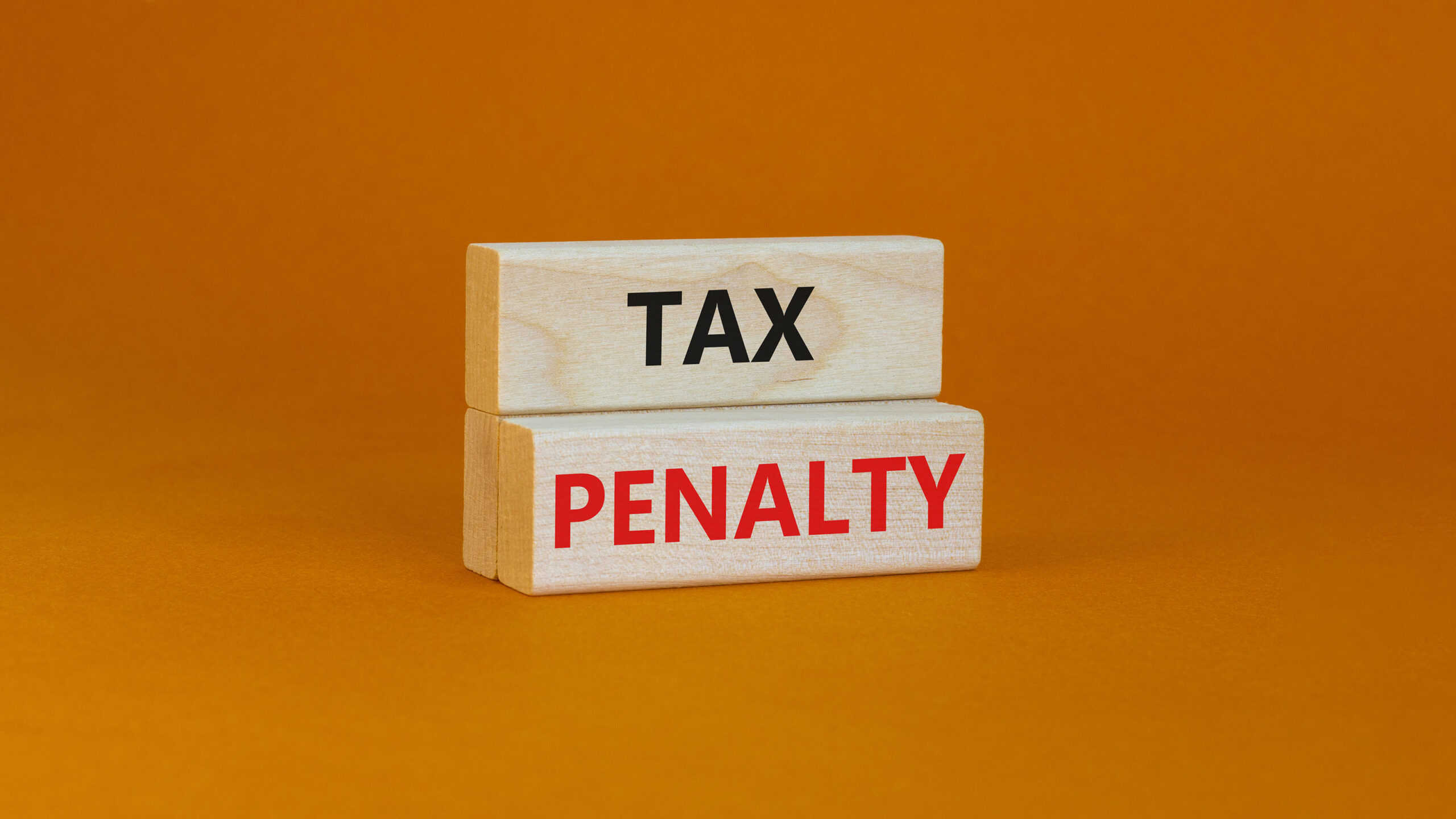 Time to tax penalty symbol. Concept words Tax penalty on wooden blocks on a beautiful orange background. Business and tax penalty concept. Copy space.